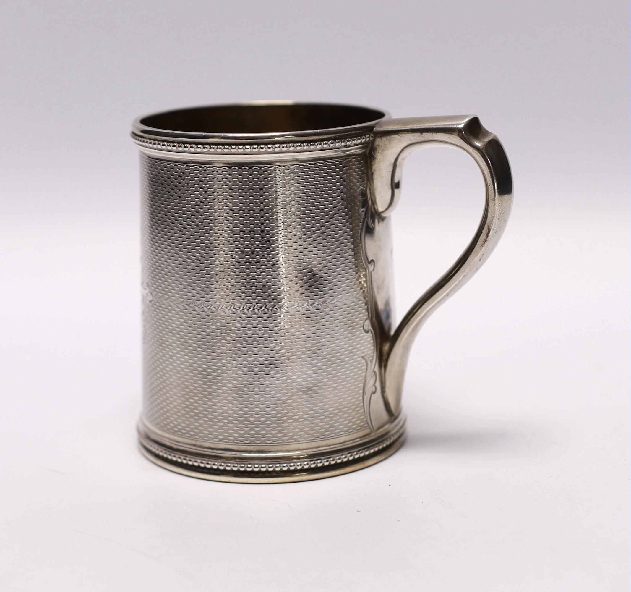 A mid 19th century Tiffany & Co (Grosjean & Woodward) engine turned sterling mug, with engraved inscription, 97mm, 6.9oz.